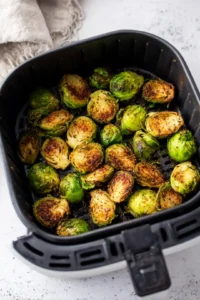 Arrange seasoned Brussels sprouts in air fryer and cook until crispy