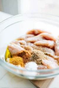 Combine chicken tenders with oil and seasoning