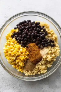 Combine cooked quinoa, black beans, corn, cumin, and paprika in a mixing bowl