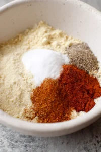 Mix together almond flour, garlic powder, onion powder, paprika, salt, and pepper in a bowl