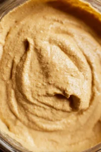 Blend soaked cashews with nutritional yeast and dijon mustard until smooth