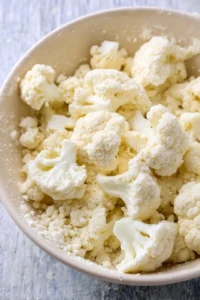 Coat cauliflower florets in flour mixture and air fry