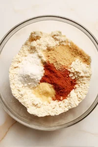 Combine the flour, garlic powder, onion powder, paprika, salt, and water to create a batter