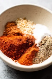 Mix paprika, garlic powder, onion powder, black pepper, and salt to create the spice blend