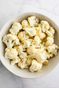 Toss cauliflower florets with olive oil, garlic powder, and salt
