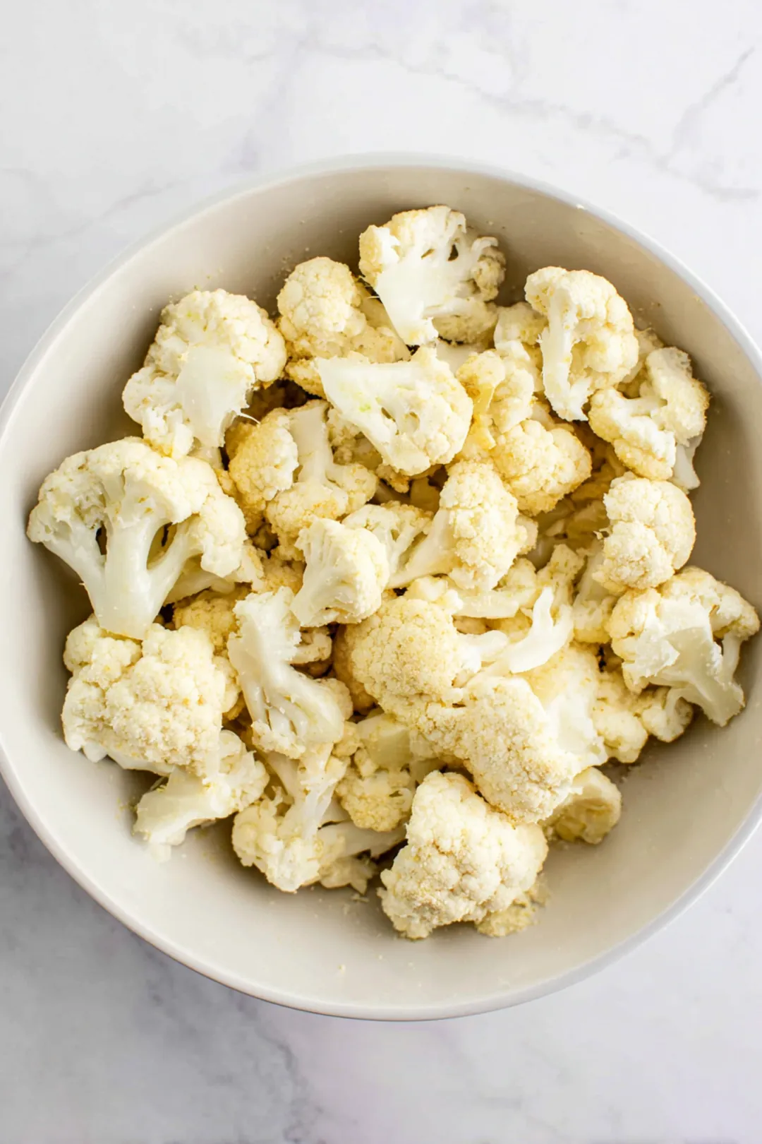 Toss cauliflower florets with olive oil, garlic powder, and salt