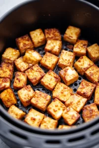 Add tofu to a sizzling skillet with oil