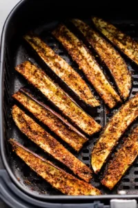 Arrange seasoned eggplant fries in the air fryer
