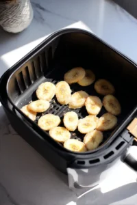 Arrange the banana slices in the air fryer