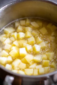 Boil diced potatoes in a large pot
