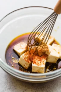 Coat tofu cubes with marinade