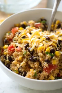 Combine cooked quinoa, black beans, corn, diced tomatoes, and shredded cheese in a large bowl