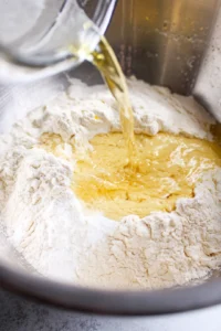Combine flour, salt, and oil in a mixing bowl