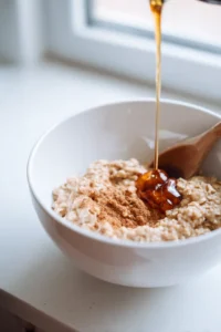 Combine mashed bananas, oats, cinnamon, vanilla extract, and maple syrup in a mixing bowl