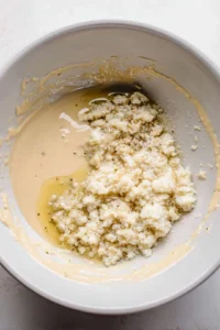 Combine tahini, minced garlic, and fresh lime juice in a bowl and mix well until smooth