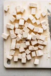 Cut tofu into 1-inch cubes after pressing for 10–15 minutes