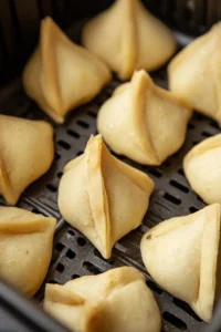 Form cones filled with potato mixture by rolling the dough into circles and cutting them in half