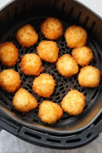 Scoop spoonfuls of batter into the air fryer basket and cook until golden brown