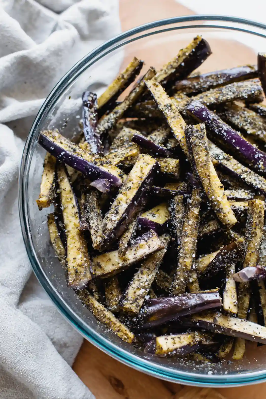 Toss the eggplant sticks with salt, pepper, and garlic powder until evenly coated