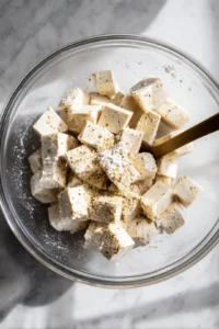 Add marinated tofu to air fryer after coating with cornstarch