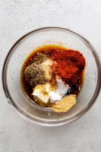 Combine the soy sauce, olive oil, garlic powder, smoked paprika, salt, and pepper with tofu in a mixing bowl