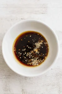 Combine the soy sauce, sesame oil, rice vinegar, and garlic powder to create the marinade.