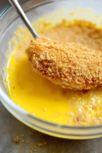Dip chicken cutlets into egg and coat with breadcrumbs