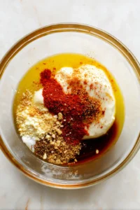 Marinate the pressed tofu in a mixture of soy sauce, olive oil, garlic powder, onion powder, smoked paprika, and red pepper flakes for 15 minutes