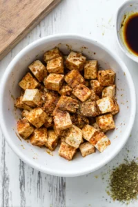 Marinate the tofu with soy sauce, olive oil, and garlic powder