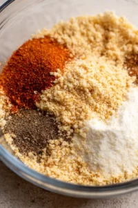 Mix bread crumbs, paprika, garlic powder, salt, and black pepper in a bowl
