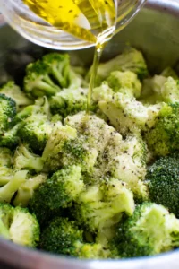 Combine broccoli with olive oil, salt, pepper, and garlic powder