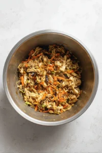 Combine shredded turkey, mixed vegetables, soy sauce, and ginger in a mixing bowl