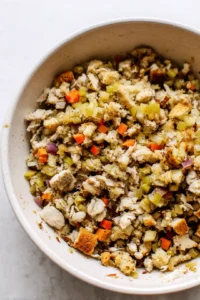 Combine shredded turkey, stuffing, and vegetables in a mixing bowl
