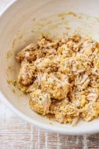 Combine shredded turkey, stuffing mix, and beaten egg in a mixing bowl