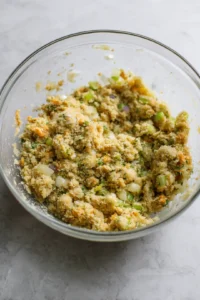 Combine the stuffing mix, chopped celery, onion, parsley, thyme, and broth in a large bowl