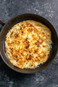 Cook the tortilla until the cheese melts and it gets crispy