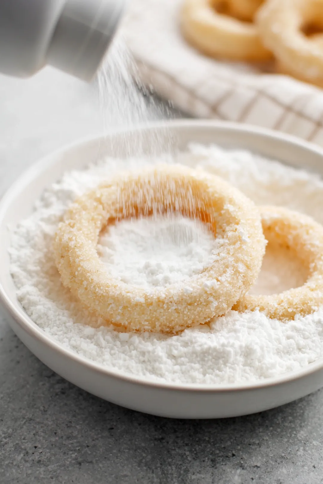 Dip onion rings into flour mixture and arrange in air fryer
