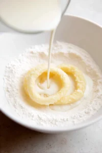 Dip the onion rings in buttermilk and coat with flour and panko breadcrumbs