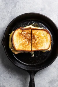 Grill the sandwich until golden brown and cheese is melted