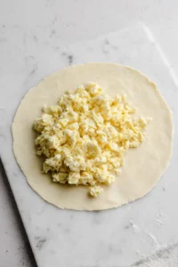 Lay an egg roll wrapper on a flat surface, place 2-3 tablespoons of the turkey mixture on the wrapper. Fold in the sides and roll tightly, sealing the end with a little water.