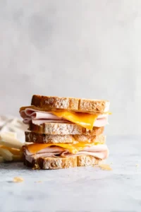 Layer turkey and cheddar cheese with hot honey on bread