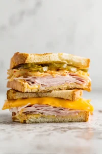 Layer turkey and kimchi on bread with cheddar cheese