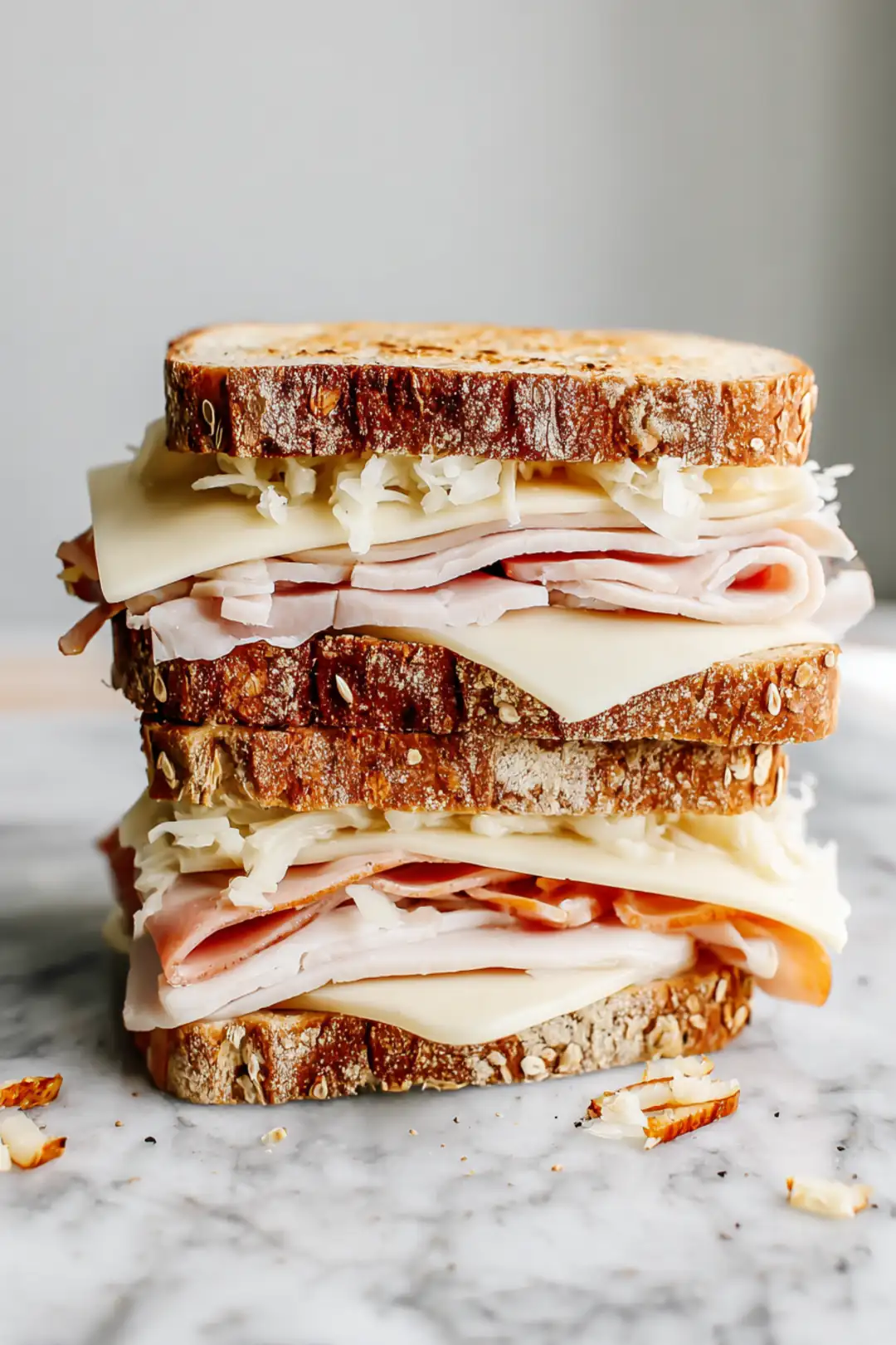 Layer turkey with sauerkraut and Swiss cheese on the bread