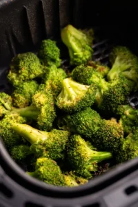 Place seasoned frozen broccoli in air fryer and cook until tender
