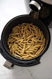 Preheat air fryer and cook seasoned pasta until crispy