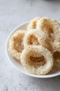 Preheat the air fryer and cook onion rings