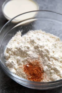 Preheat the air fryer to 375 degrees Fahrenheit and prepare the buttermilk mixture