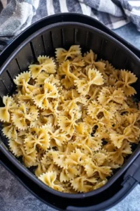Preheat the air fryer to 400°F and cook pasta until crispy
