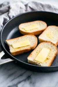 Preheat the skillet and butter the bread