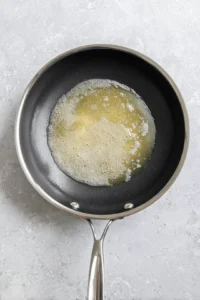 Preheat the skillet and melt butter